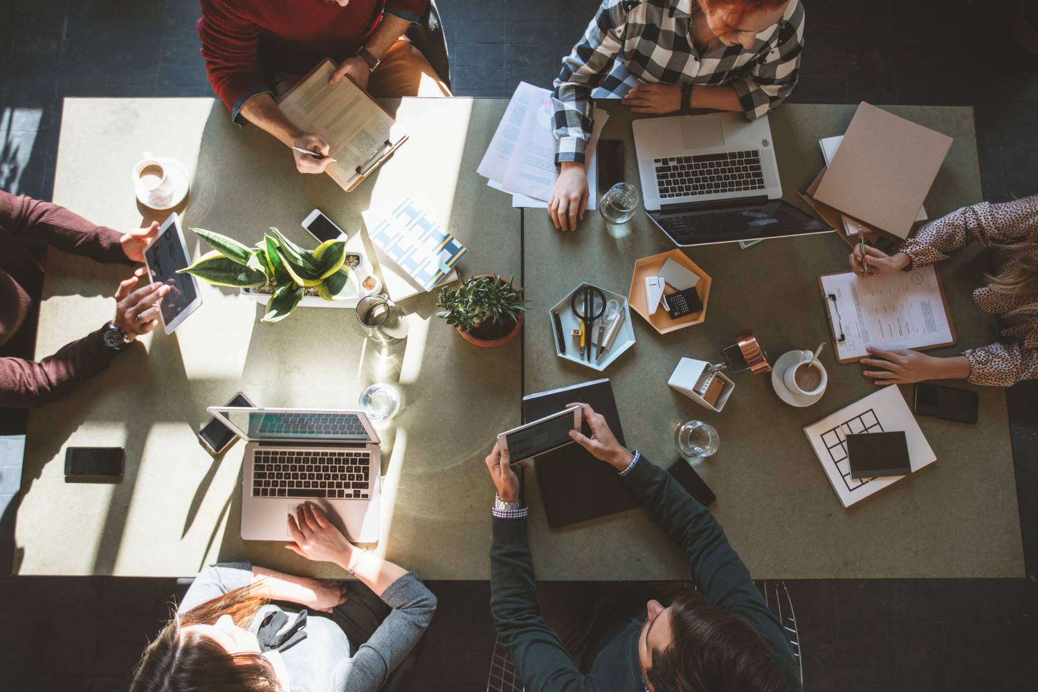 People sitting at meeting table from above