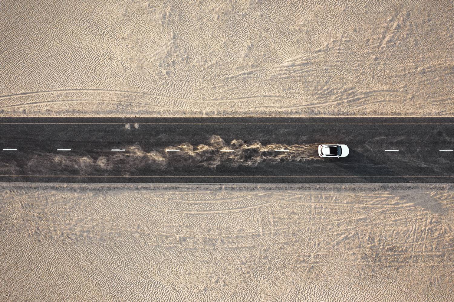 Car Driving On Desert Road