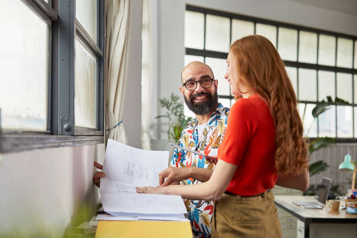 Man and woman talk by window