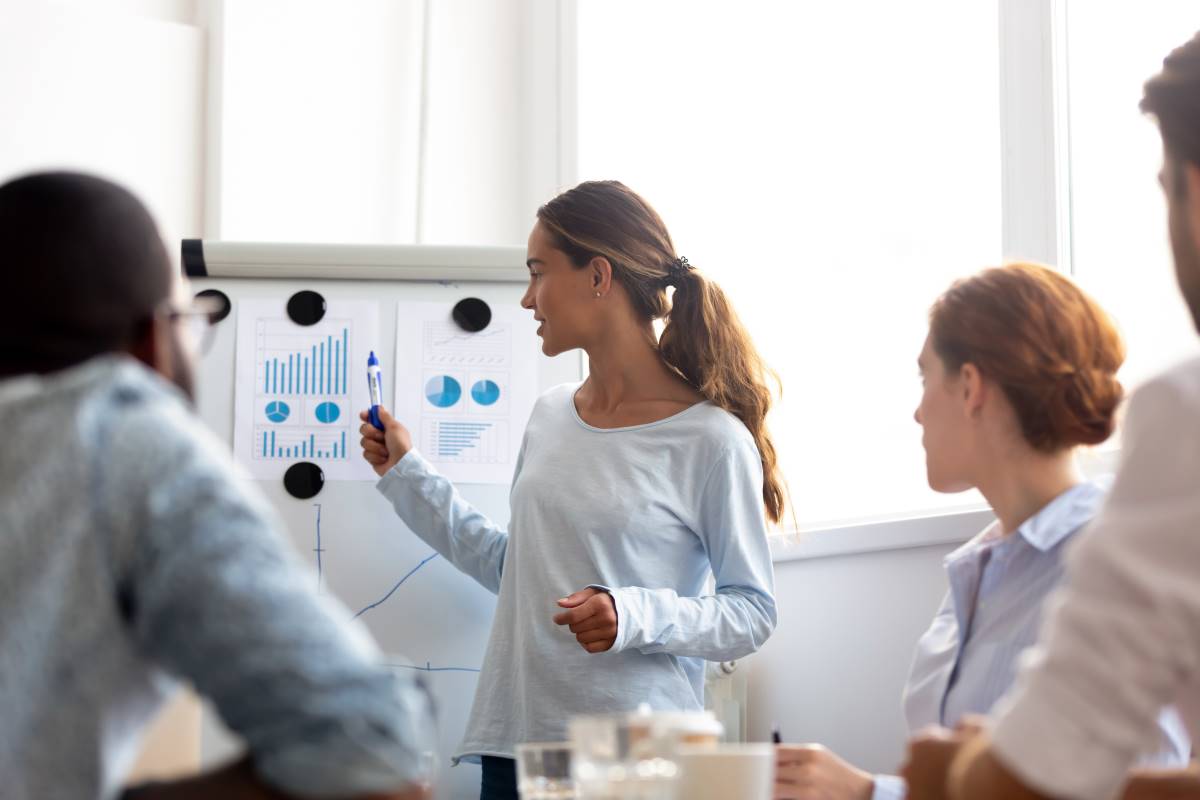 Businesswoman_Leading_Meeting_with_Charts Woman Presenter Flipchart