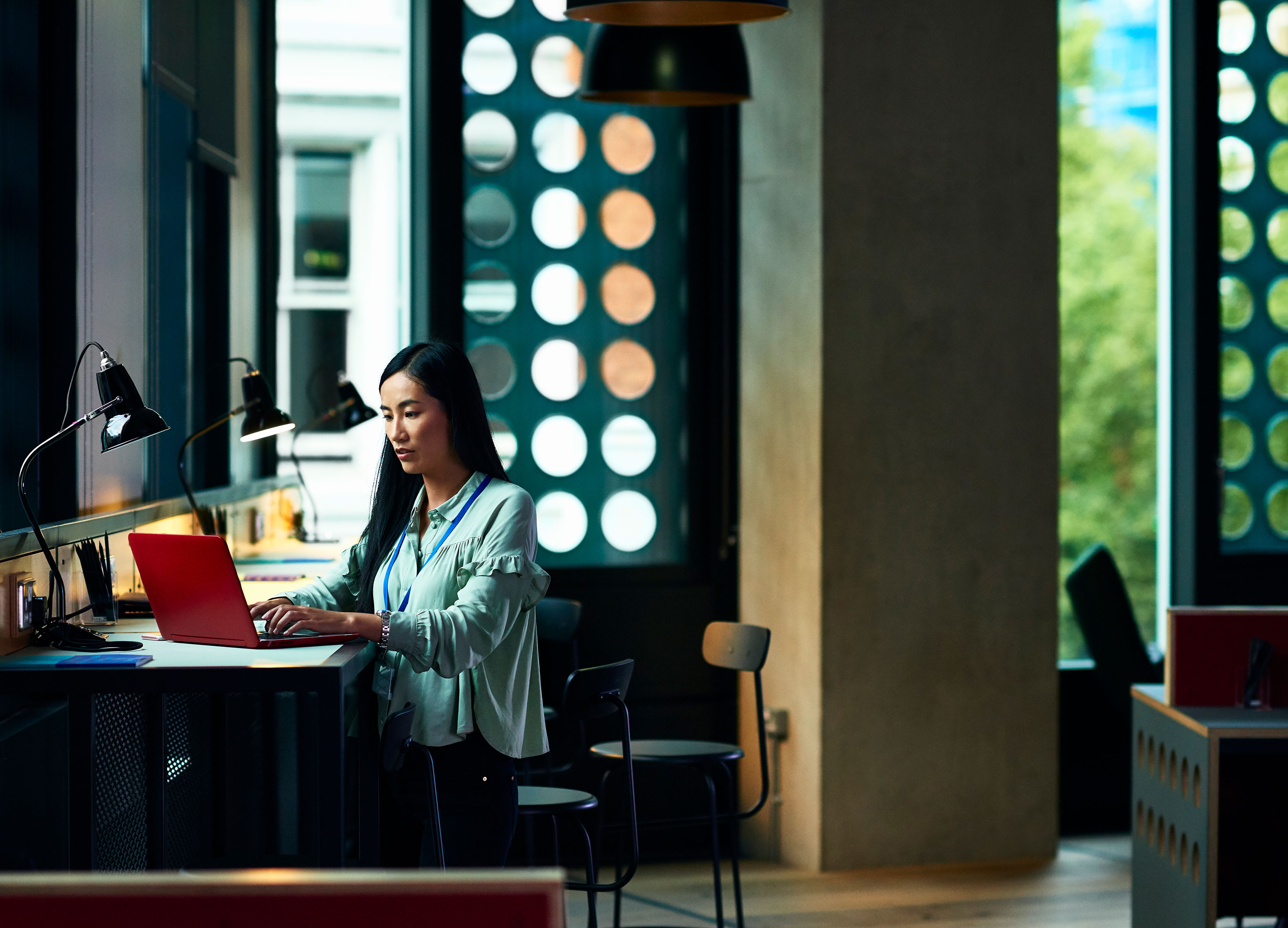 Asian_Woman_Remote_Working_on_Laptop Woman using laptop in office