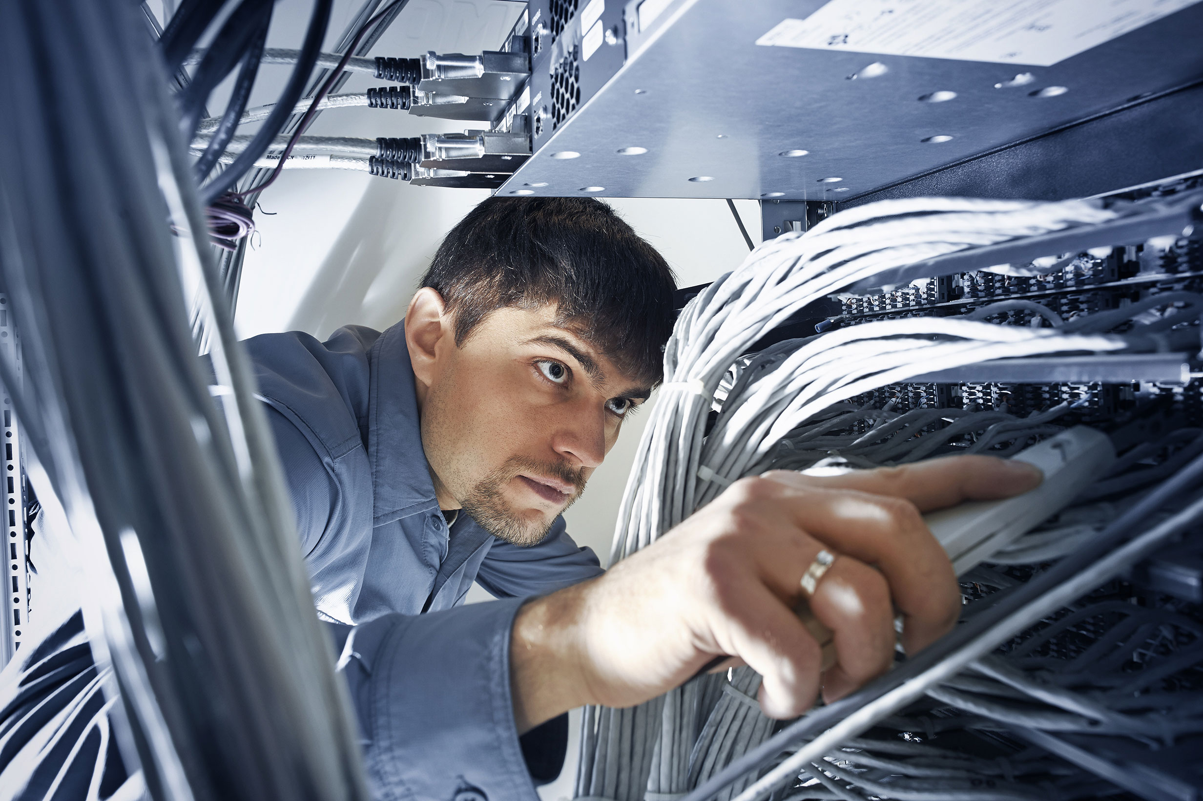 Technician_Checks_Wires_In_Data_Center