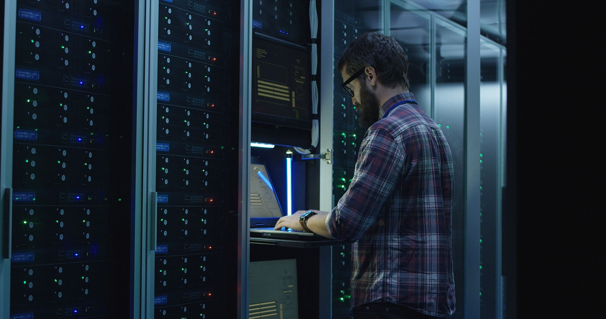 IT_Technician_In_Dark_Server_Room