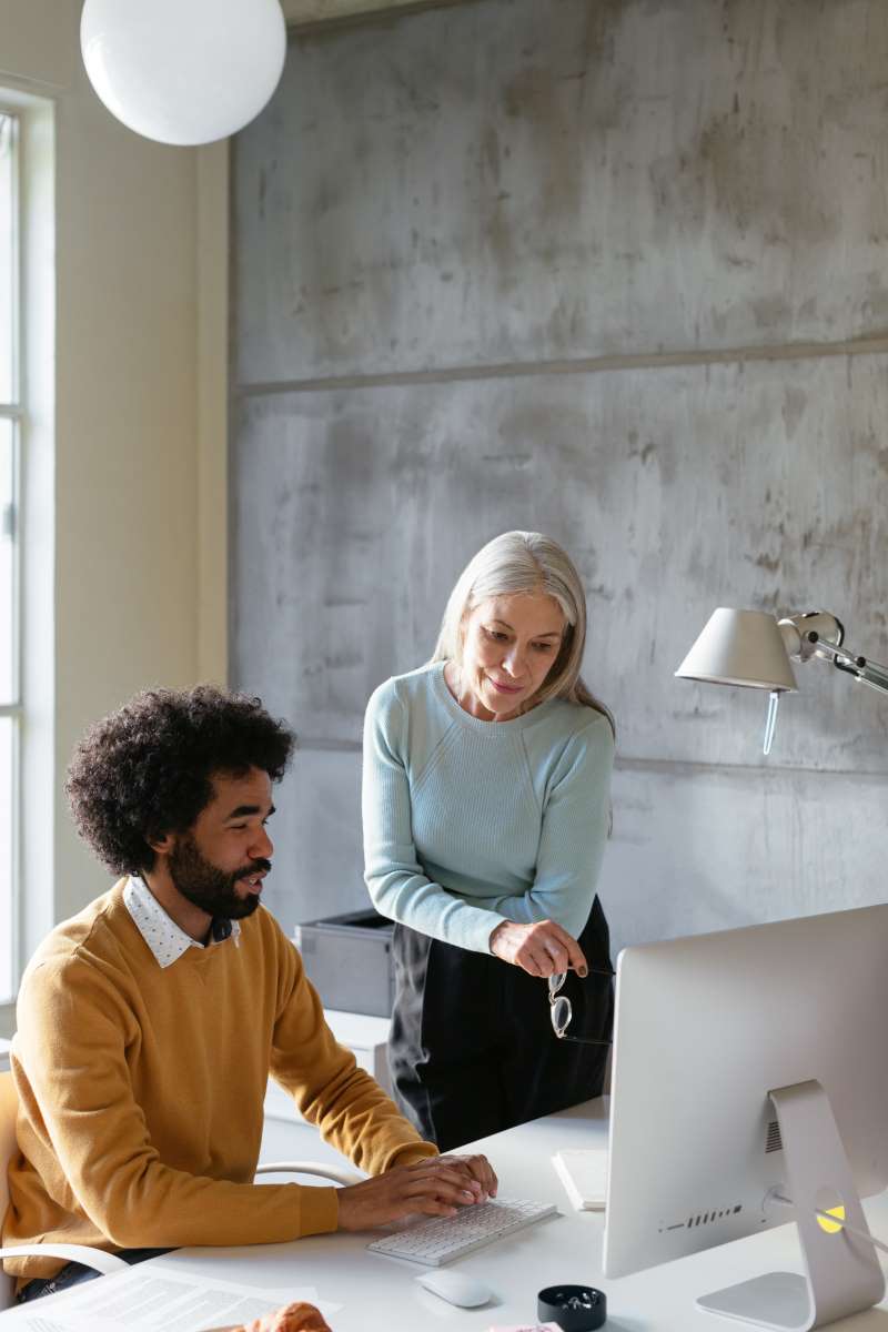 African_American_Male_and_Caucasian_Female_at_Computer Man and woman look at computer screen