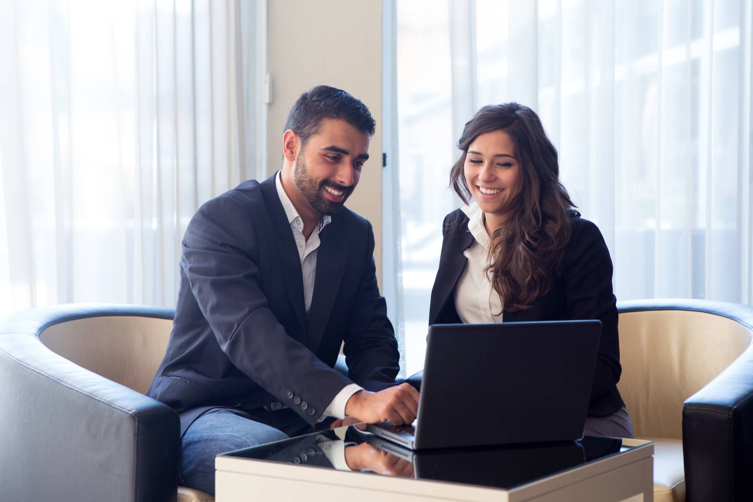 Two_Businesspeople_Meeting_Over_Laptop